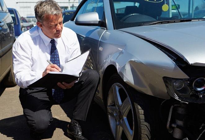 a traffic accident with cars and an insurance agent at the scene